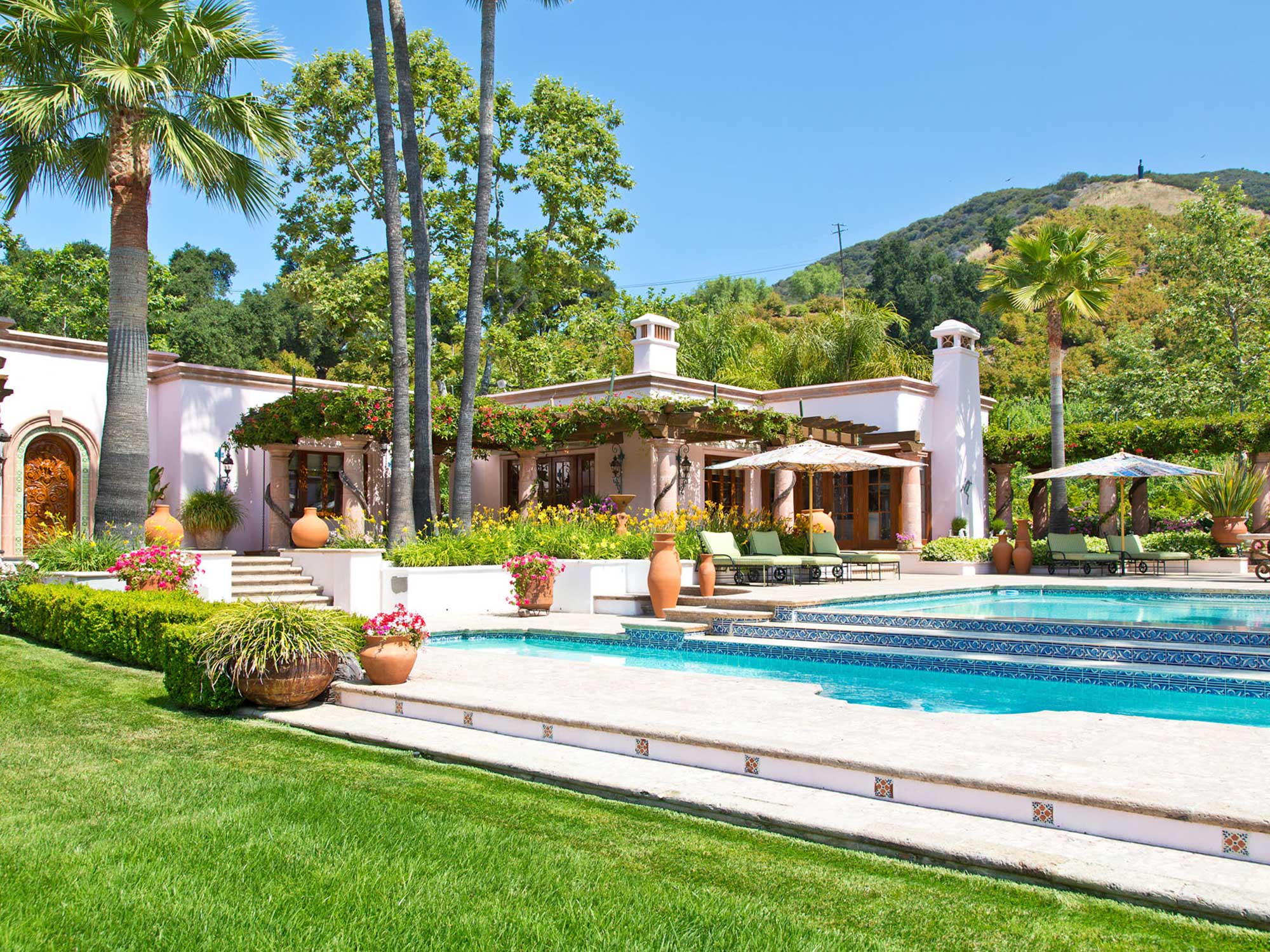 image of main house at the Rosenthal Estate with swimming pool and palm trees